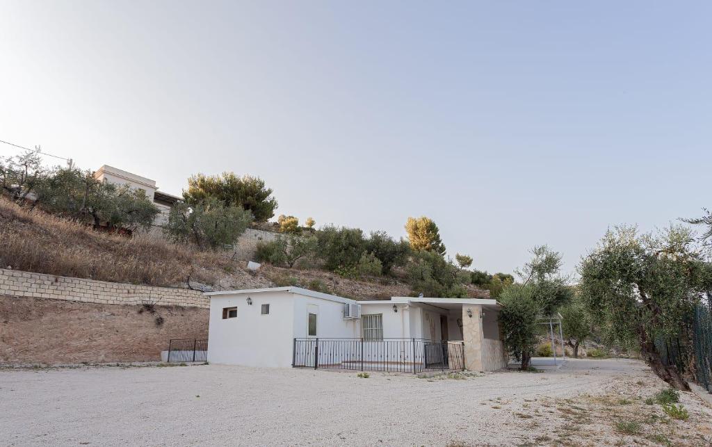 a white building on the side of a hill at Bed and Breakfast Brezza Marina 2 in Mattinata