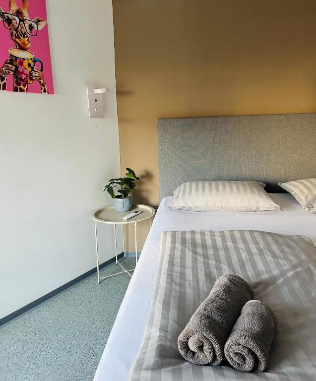 a bedroom with a bed with two towels on it at Hostel POINT Nova Gorica, Self Check-In with code access in Nova Gorica