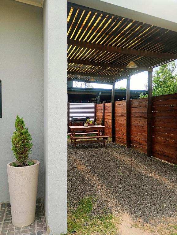 a patio with a bench and a wooden fence at LIVe in Villa Elisa