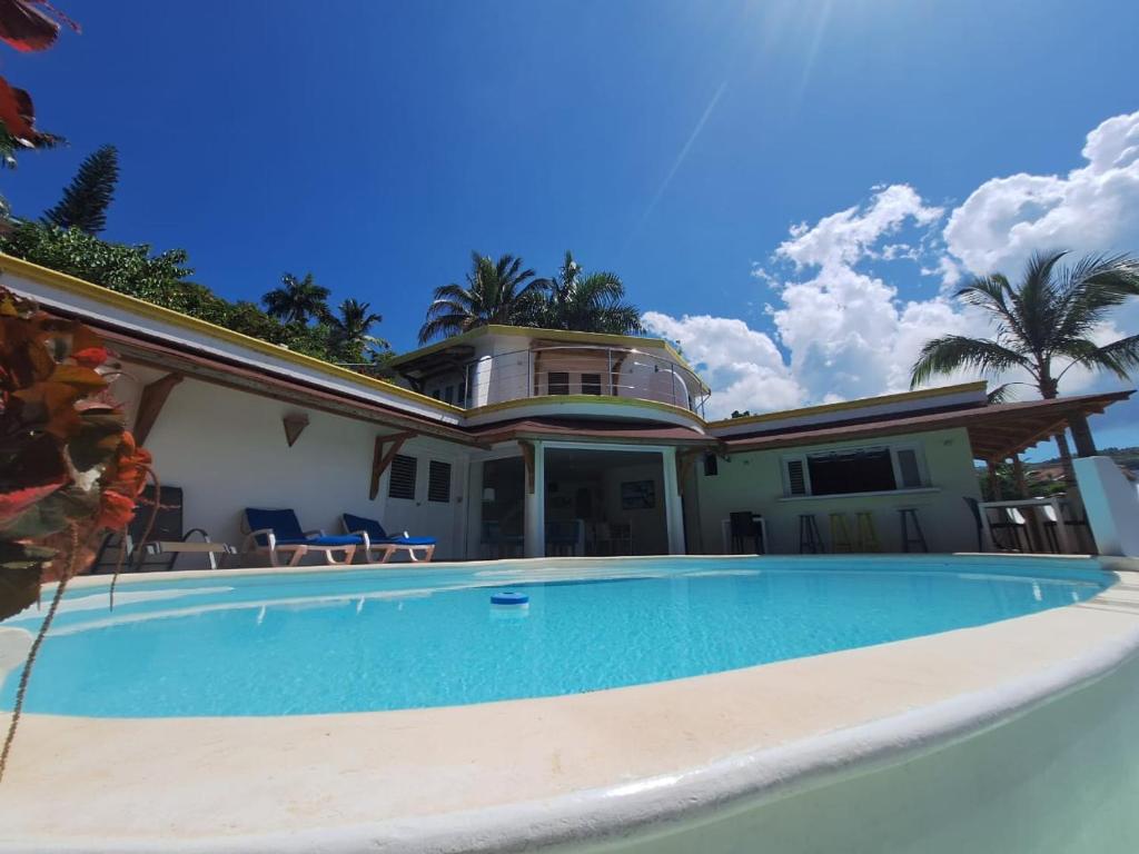 a house with a swimming pool in front of it at villa vue mer - piscine privée in Las Terrenas