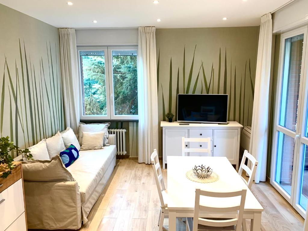 a living room with a couch and a table at Modern 90sqm Apt - Ideal Base for Parma & Modena in Cavriago