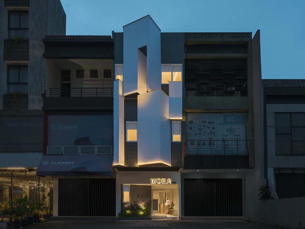 a building with a voxel sign in front of it at Mora Stay Demangan RedPartner in Yogyakarta