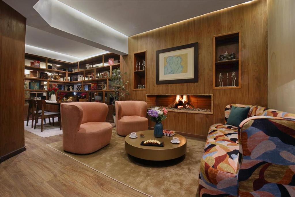 a living room with a couch and chairs and a fireplace at Park Suites Hotel Luxury Boutique Hotel in Casablanca
