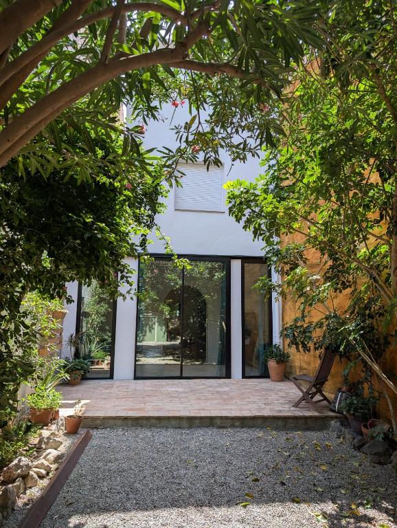 an internal view of the house through the trees at Ca la Lola Estartit in L'Estartit
