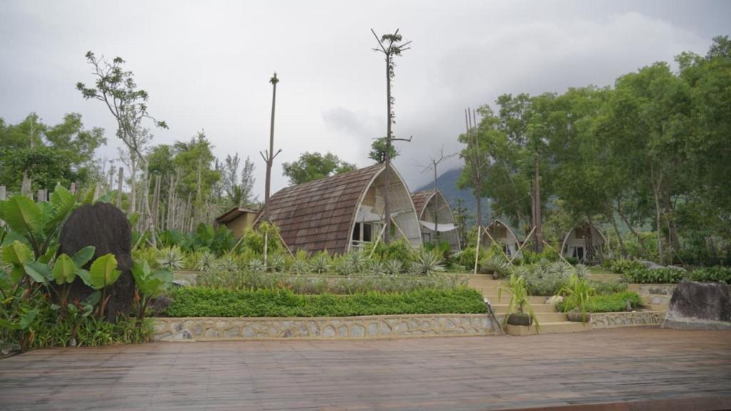 a garden with a building in the middle of it at Natuna Garden Villa in Ranai