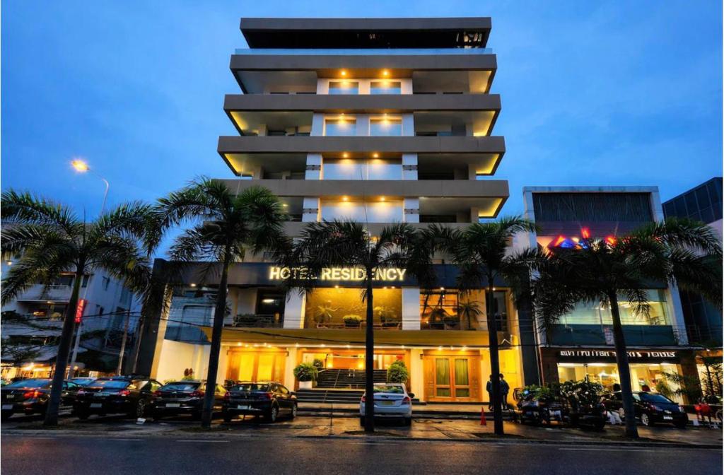 a building with a man standing in front of it at RESIDENCY HOTEl in Jāmb