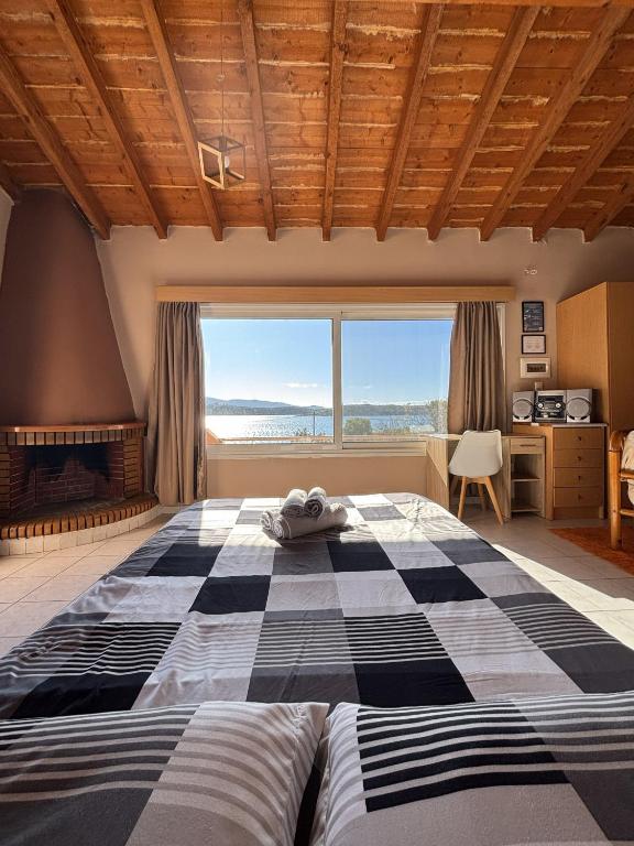 a bedroom with a large bed with a checkered floor at Aegean Window - Sea View Studio in Salamina