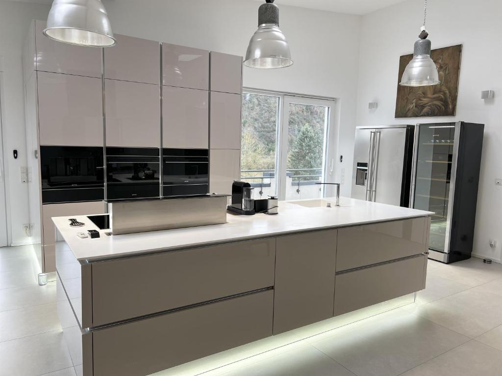 a large kitchen with white counter tops and appliances at LOFT - Exclusive Penthousewohnung in Könen