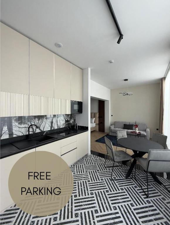 a living room with a table and a kitchen at Soho Boutique apartments in Ljubljana