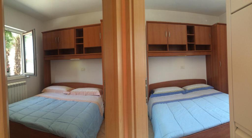 Postel nebo postele na pokoji v ubytování Apartments Lili