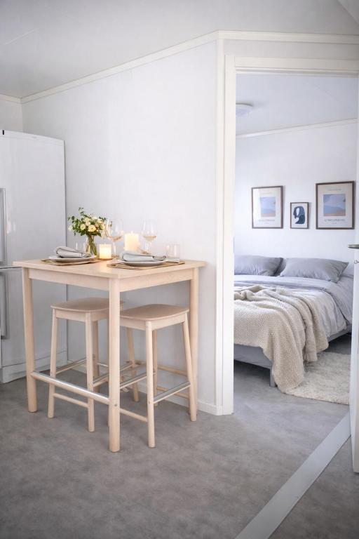 a room with a table and a bed and a bed sqor at Frost Longstay Lakeside in Kiruna
