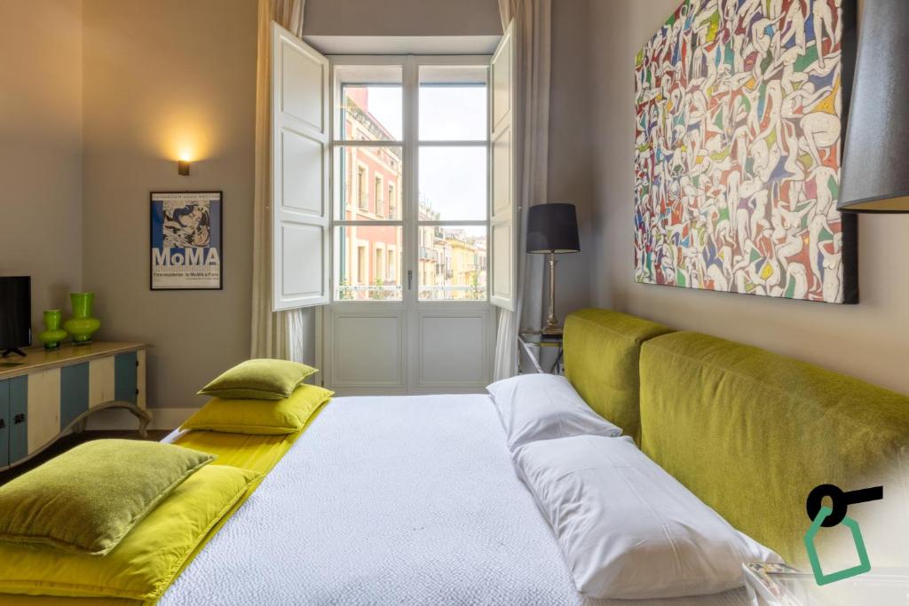 a living room with a couch and a window at Hotiday Cagliari Porto in Cagliari