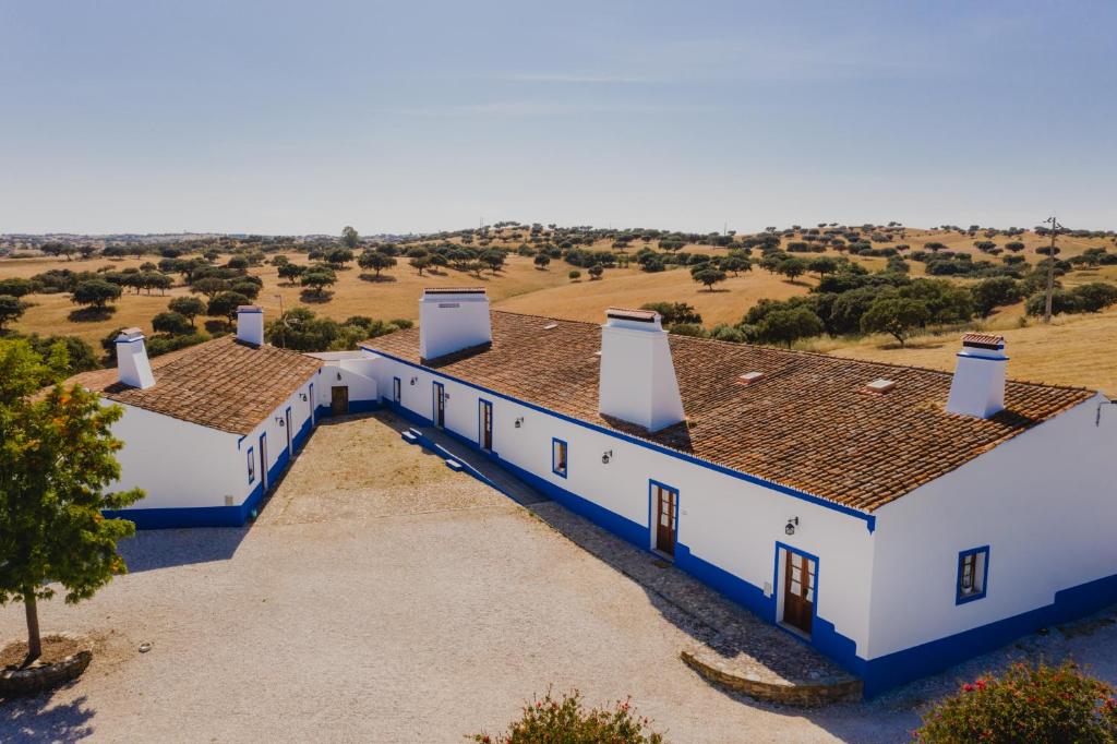an aerial view of two white buildings with brown roofs at Herdade dos Mestres in Terena