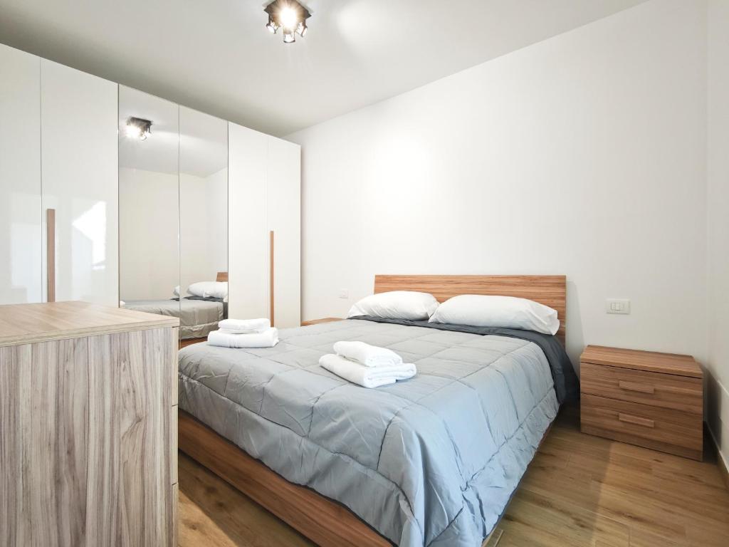 a bedroom with a large bed with two towels on it at Gentilè in Bari
