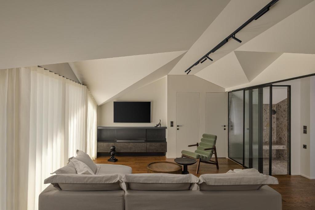 a living room with a couch and a tv at The Lake Loft in Ioannina