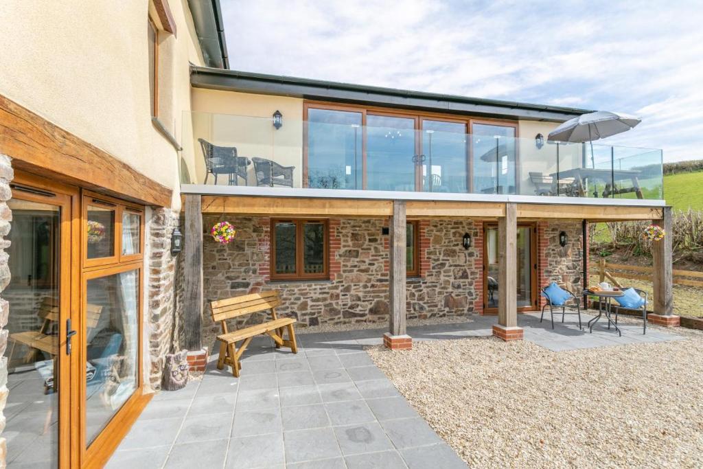 a house with glass doors and a patio at 3 Bed in Bish Mill oc-e30946 in Bishops Nympton