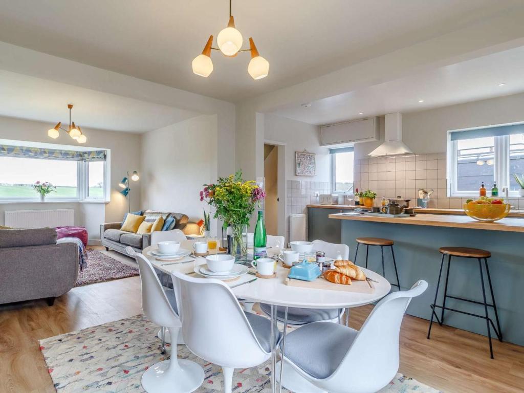 a kitchen and living room with a table and chairs at 3 Bed in Kings Lynn oc-82358 in Harpley