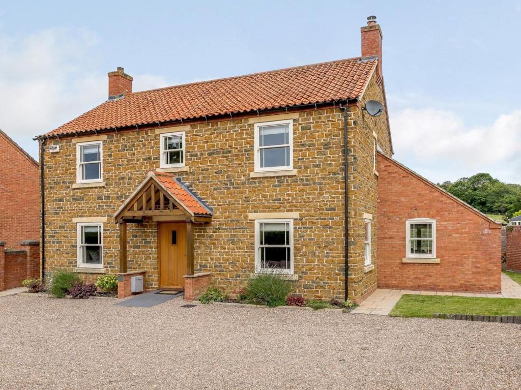 an old brick house with a brown door at 5 Bed in Market Rasen oc-78678 in Tealby