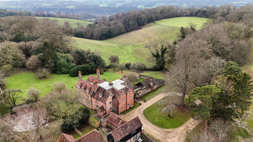 an aerial view of an old house in a field at Huckleberry Farm House in Basildon