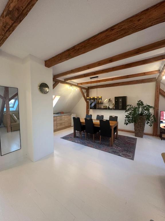 a dining room and living room with a table and chairs at Gemütliche Wohnung in Burg in Burg bei Magdeburg