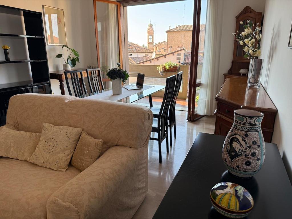 a living room with a couch and a table at L' Atelier sui Tetti in Faenza