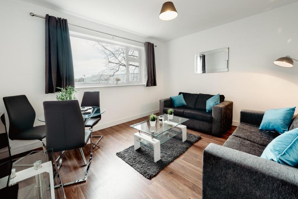 a living room with a couch and a table at K Suites - Station Road 13 in Hinckley