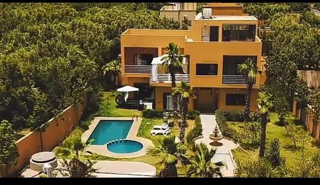 an aerial view of a house with a swimming pool at Villa isouktan in Sbiti
