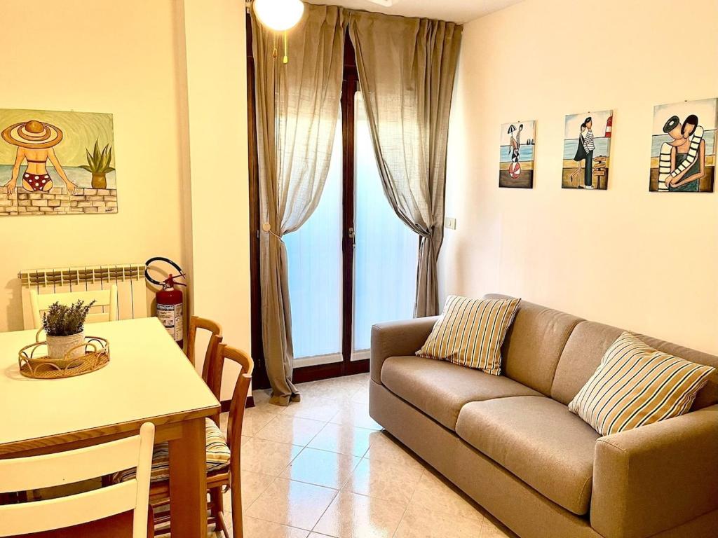 a living room with a couch and a table at Grado Dolce Vita beachfront in Grado