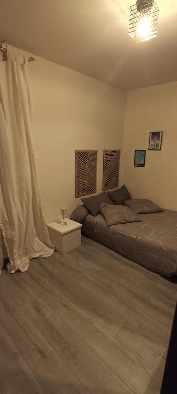 a bedroom with two beds and a table in it at Chambre double avec lit clic clac in Saint-Pardoux-Isaac