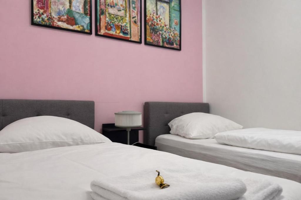 two beds with a toy duck sitting on top of them at NEST by Tendo Stay - Comfort Housing in Falkensee