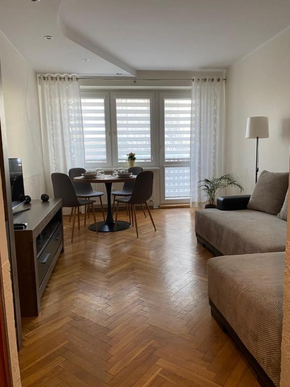 a living room with a table and a couch at Apartament 94 Konin in Konin