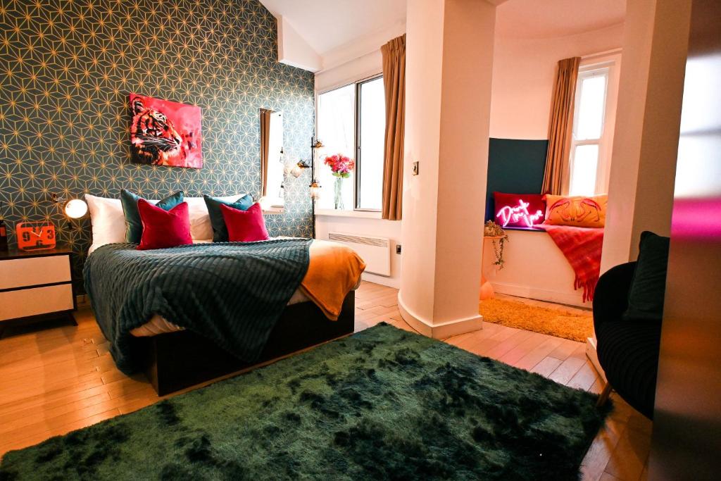 a bedroom with a bed and a couch and windows at Starr Place in Liverpool