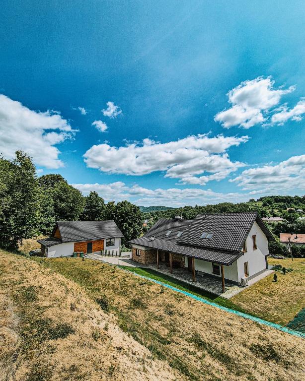 a house on a hill next to a field at Janowe Wzgórze in Cieszyna