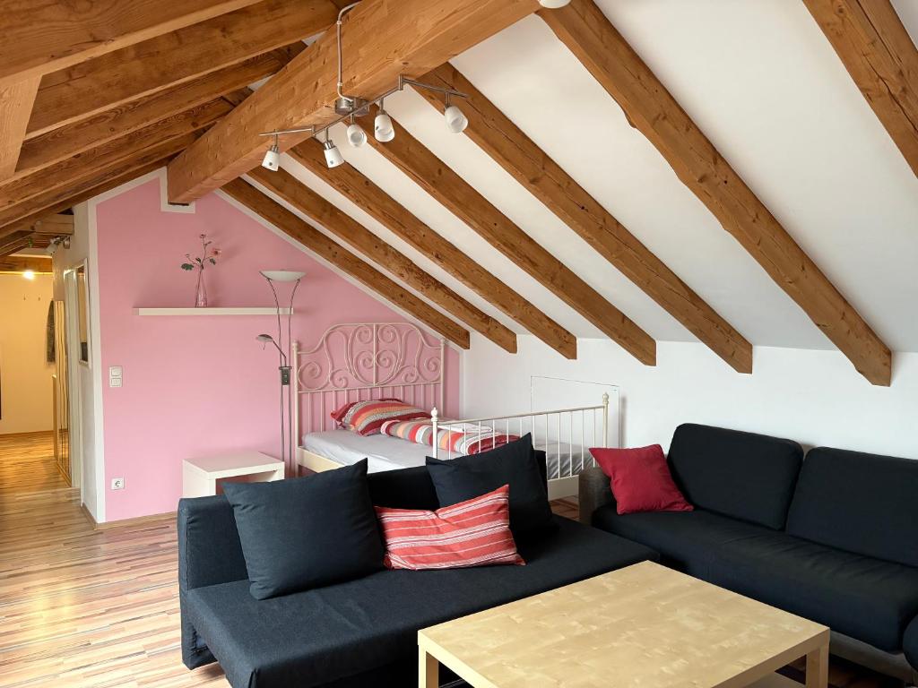 a living room with a couch and a bed at Delfinia in Althegnenberg