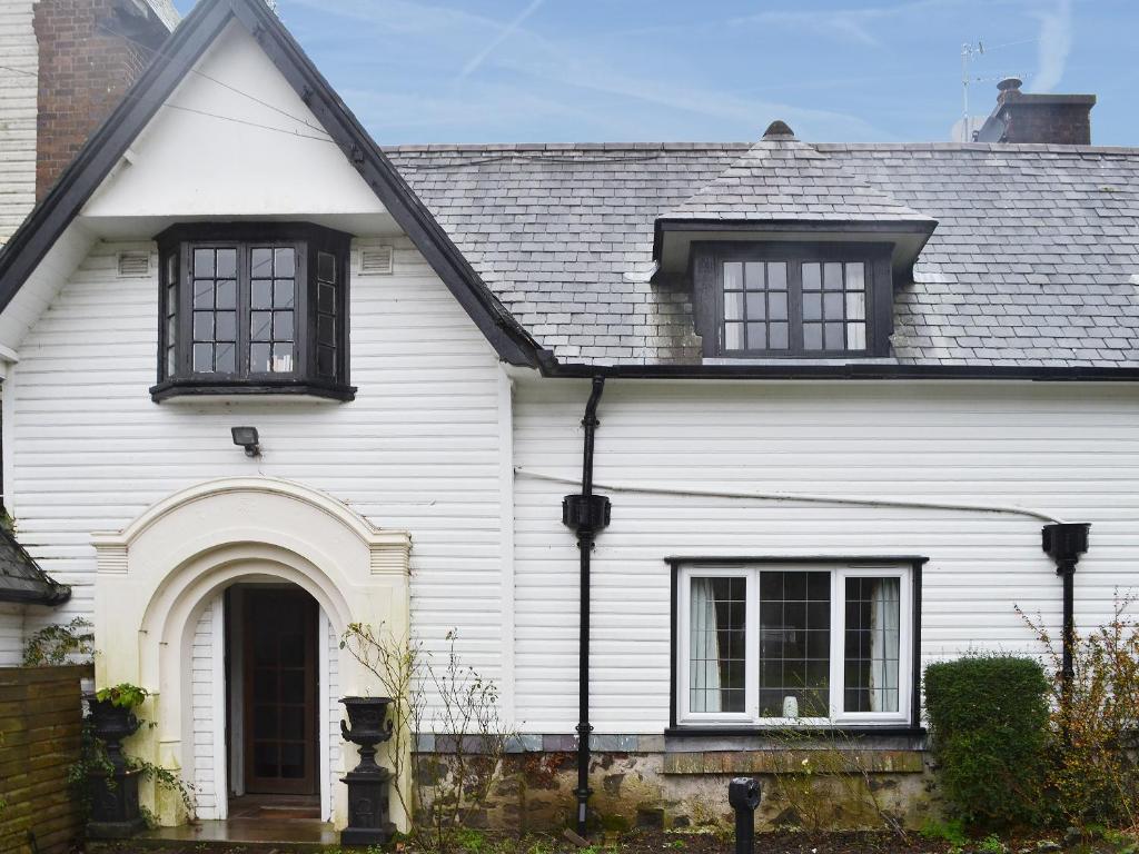 a white house with two windows and a roof at Hawthorn in Llanddona