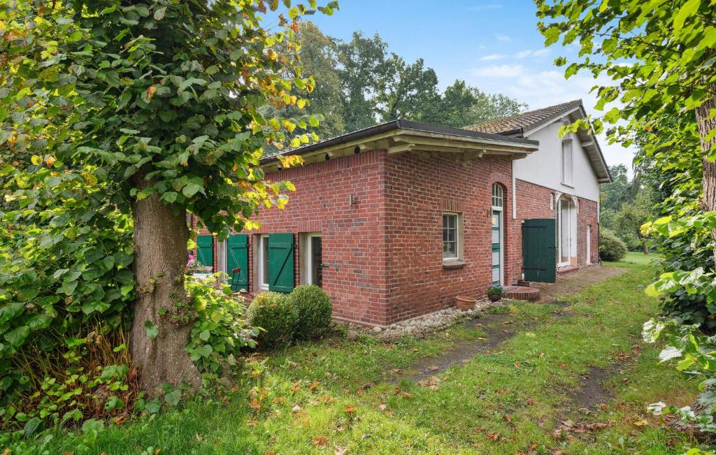 a brick house with a tree in the yard at Beautiful Apartment In Wingst in Wingst