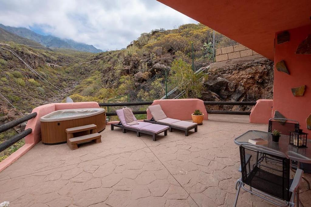 a patio with chairs and a table and a view of a mountain at Apartamento Vulcano in Adeje