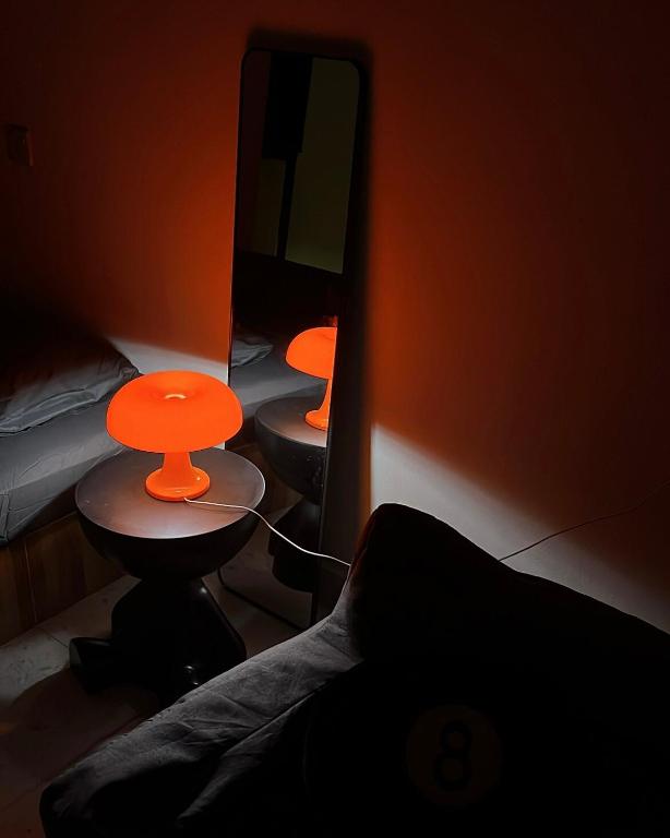 a room with two beds and a table and a mirror at Temin Roomstay in Pulau Langkawi