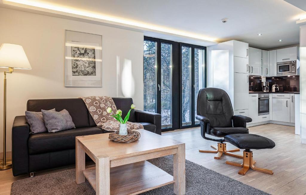 a living room with a couch and a chair at Garden Suite in Binz