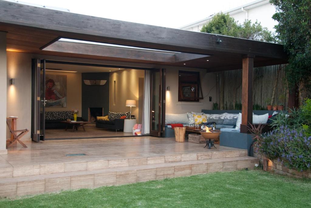 an outdoor patio with a wooden pergola at Wessels House in Cape Town