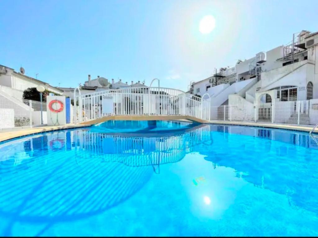 a large pool with blue water in front of buildings at Laguna 88 in La Mata