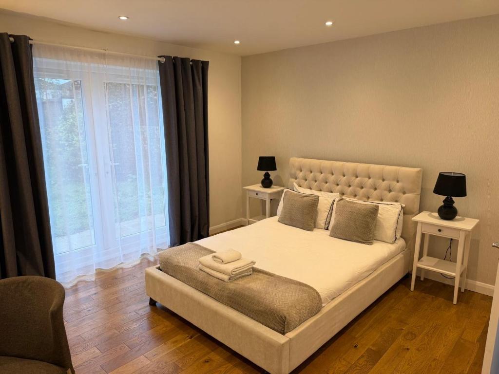 a bedroom with a large bed with two night stands at St Joseph's Guest House in Southampton