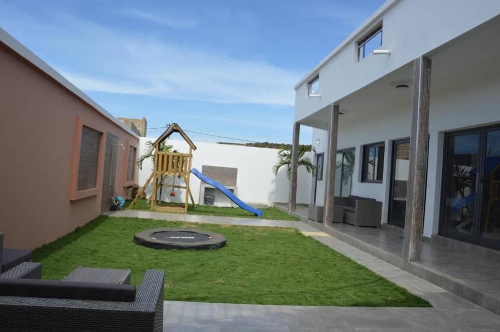 a yard with a playground in the middle of a house at Villa Keur Carla in Niangol