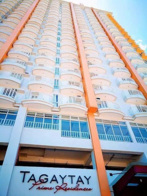 a tall building with a taccoagency sign in front of it at Beloved's Homestay in Iruhin