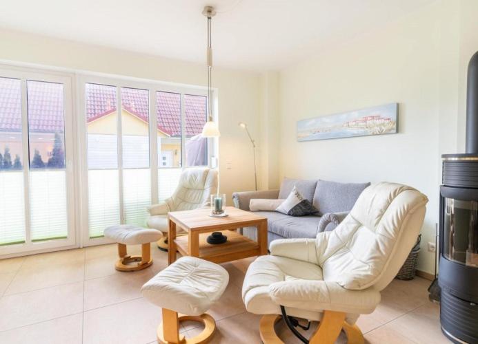 a living room with a couch and a table at Haus Hanse in Korswandt