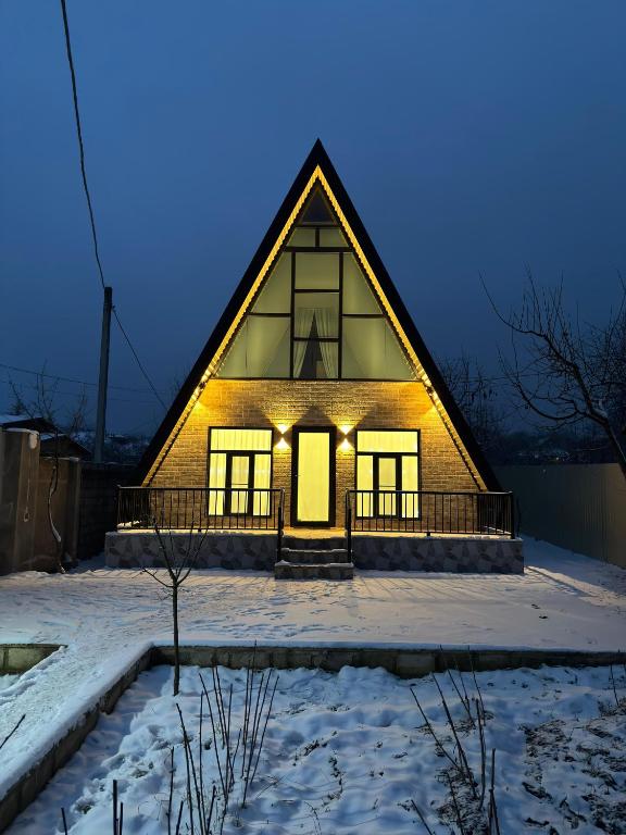 a house in the snow with lights on at Boss House in Quba