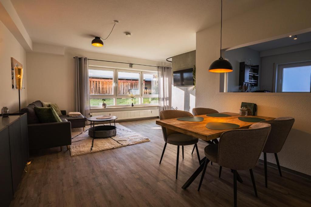 a living room with a wooden table and a dining room at Hannas Lieblingsplatz in Marburg an der Lahn