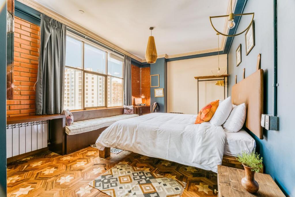 a bedroom with a bed and a large window at Martí in La Paz