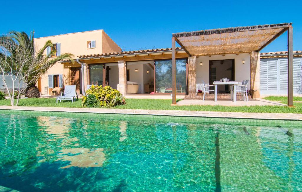 a house with a swimming pool in front of a house at Ca Ses Nines in Cala Bona