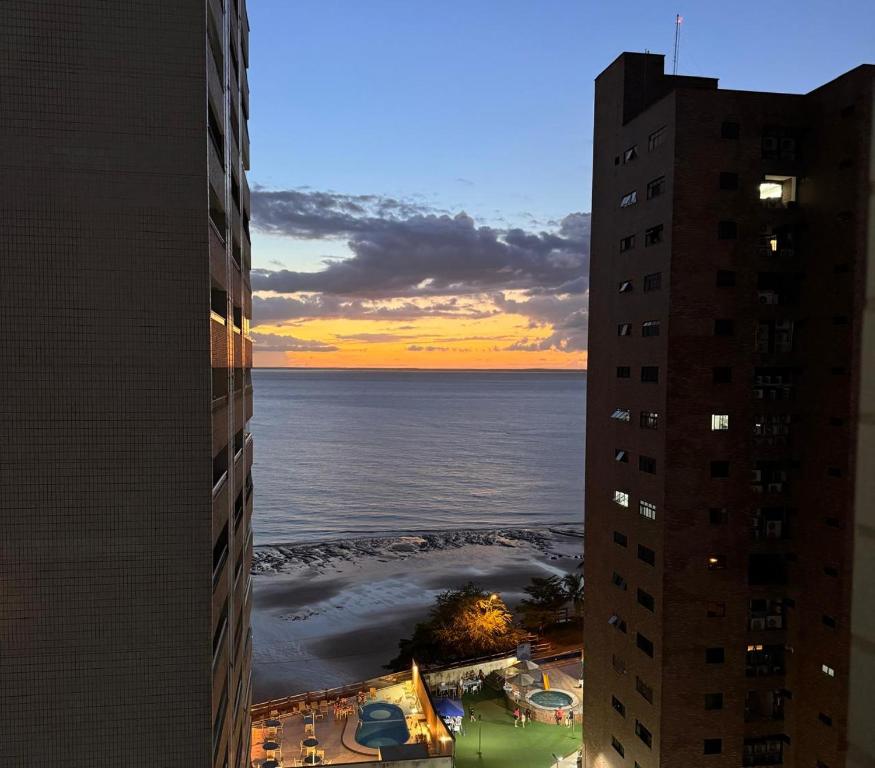 a view of the ocean from between two buildings at Mar doce lar in São Luís